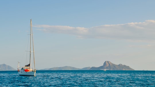 sailboat on sea near mountain during daytime in Whitsundays QLD Australia