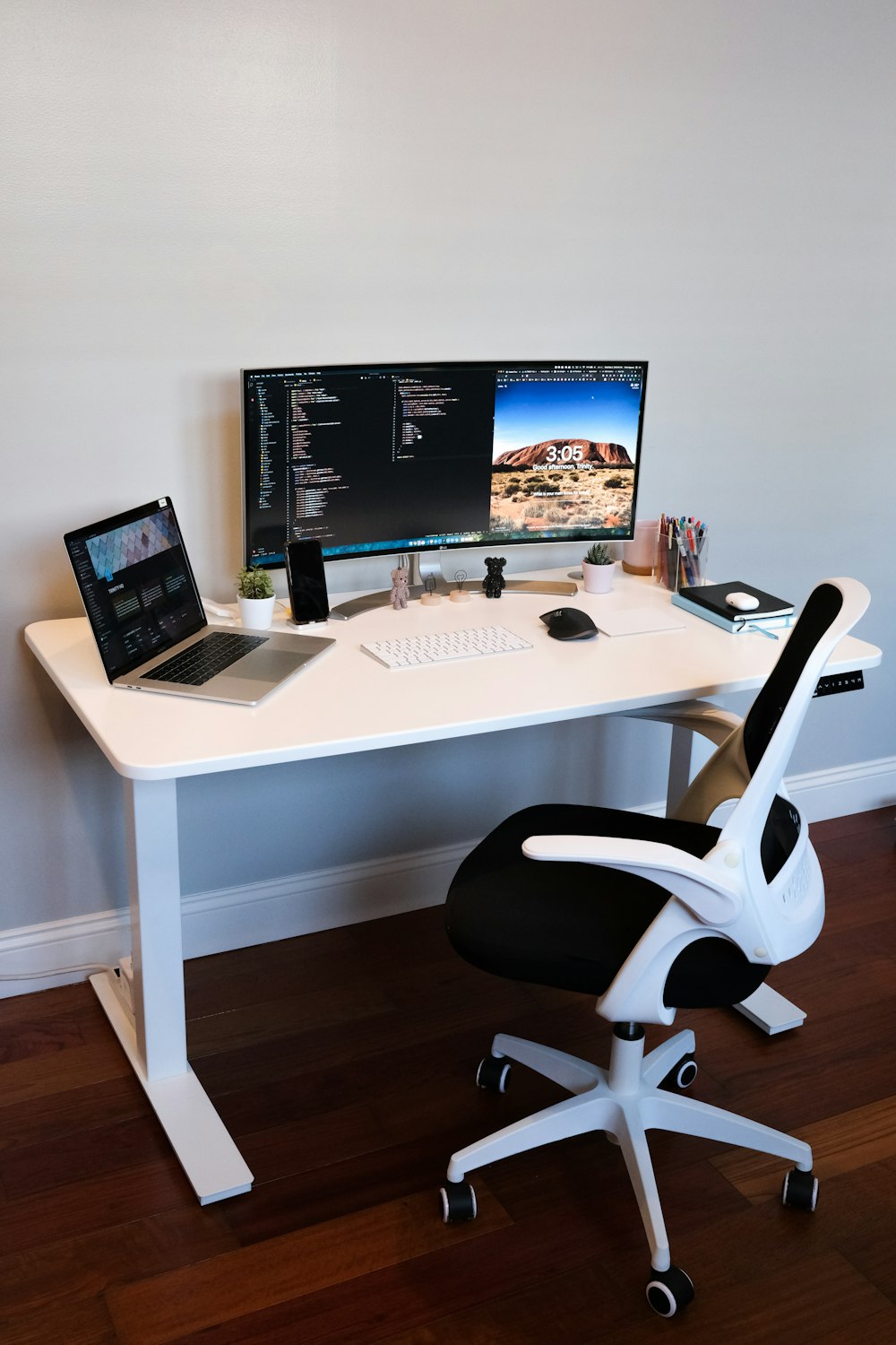 black flat screen computer monitor on white wooden desk