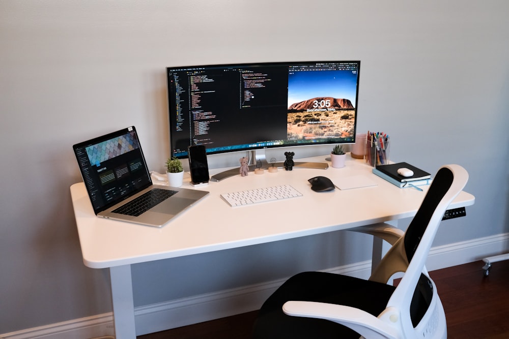 silver imac on white wooden desk