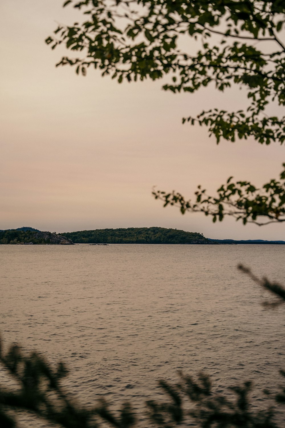 body of water near mountain during daytime