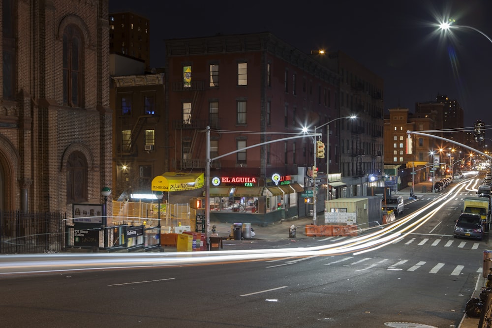 cars on road near brown concrete building during night time