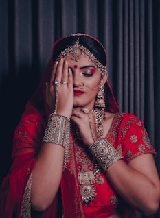 woman in red and gold sari