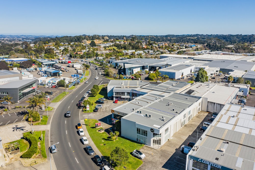 cars parked on parking lot near white building during daytime