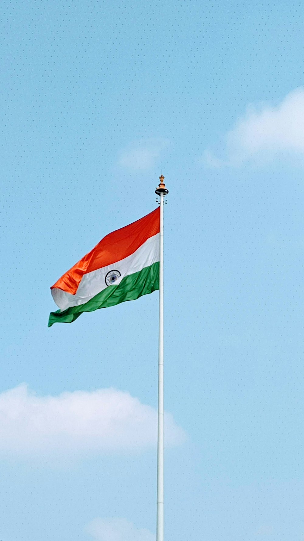 green white and red flag on pole under blue sky during daytime