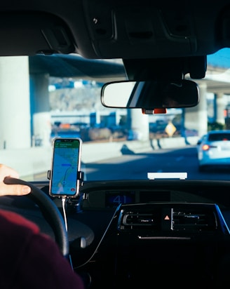 person holding iphone 6 inside car