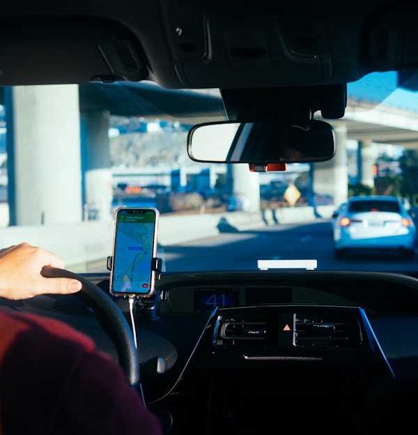 person holding iphone 6 inside car