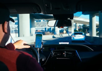 person holding iphone 6 inside car