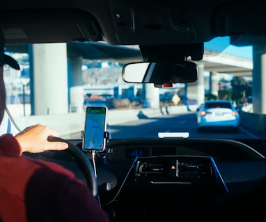 person holding iphone 6 inside car