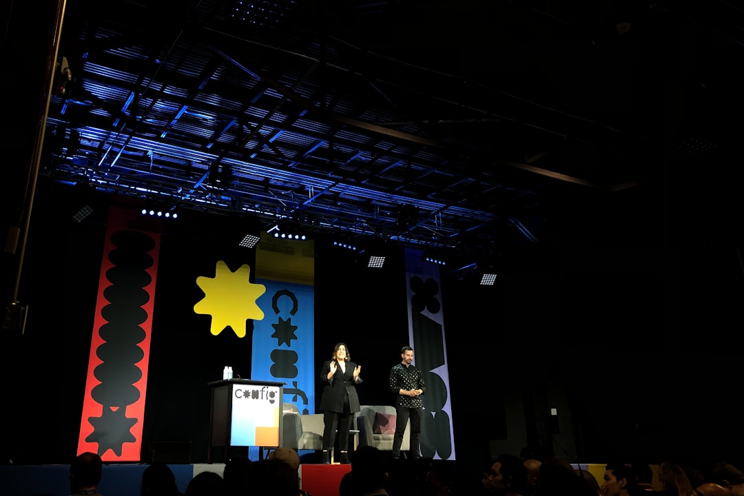 people standing on stage with red yellow and blue star flag