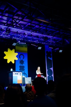 people standing on stage with star on wall