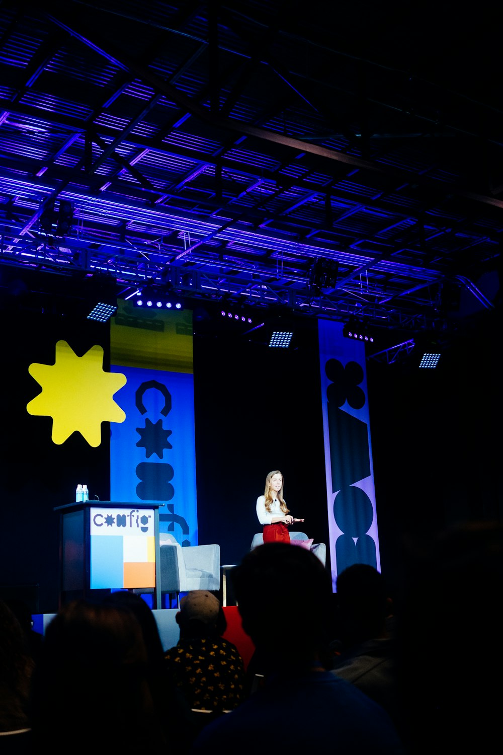 people standing on stage with star on wall