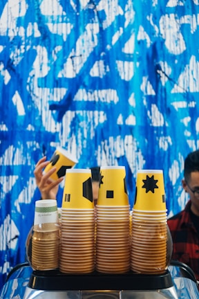 Stack of 4oz personalized coffee cups with a modern geometric pattern.