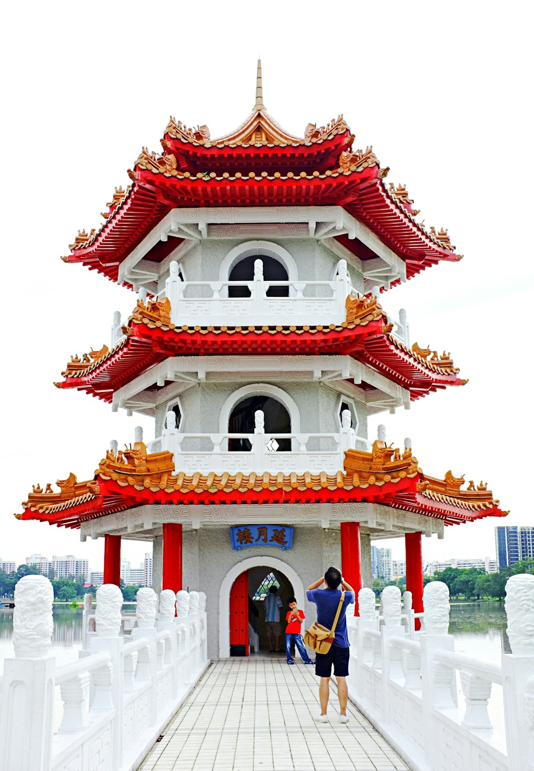 people walking on red and white concrete building during daytime