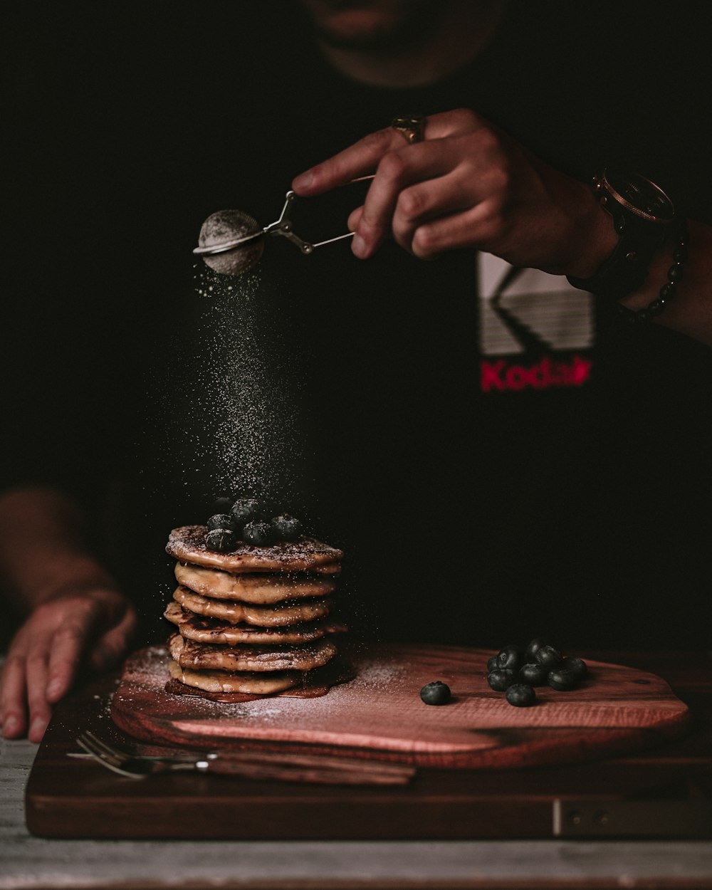 person pouring water on chocolate cookies