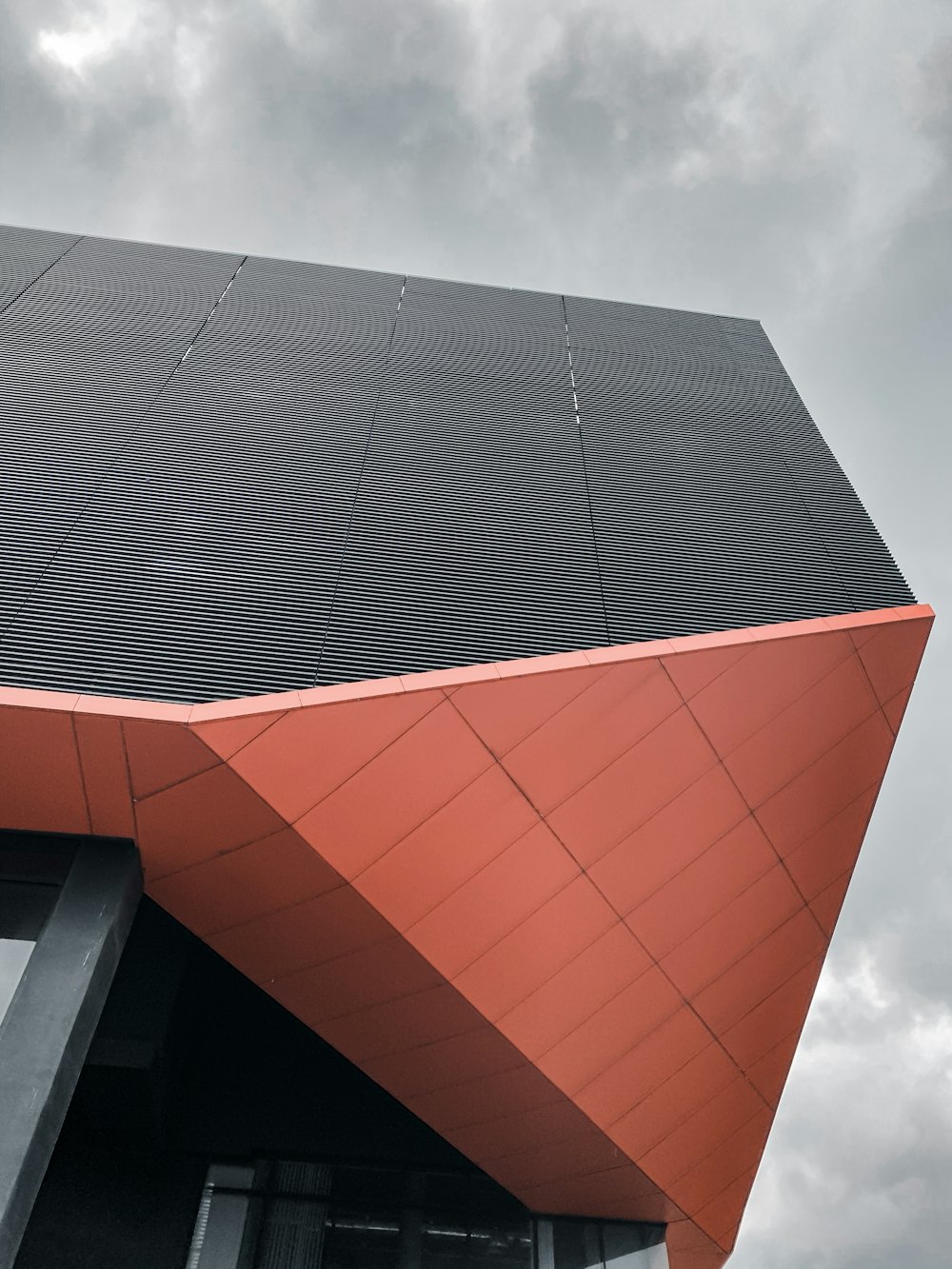 red and black concrete building under white clouds during daytime