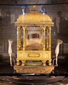 A golden throne adorned with intricate carvings and shining jewels, bathed in warm light.