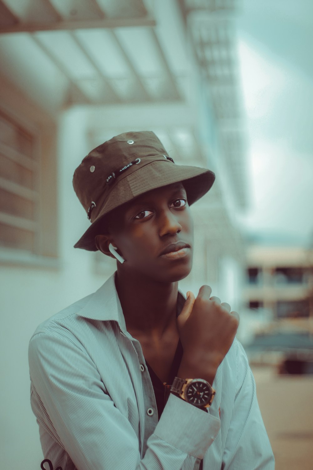 woman in white button up shirt wearing brown hat