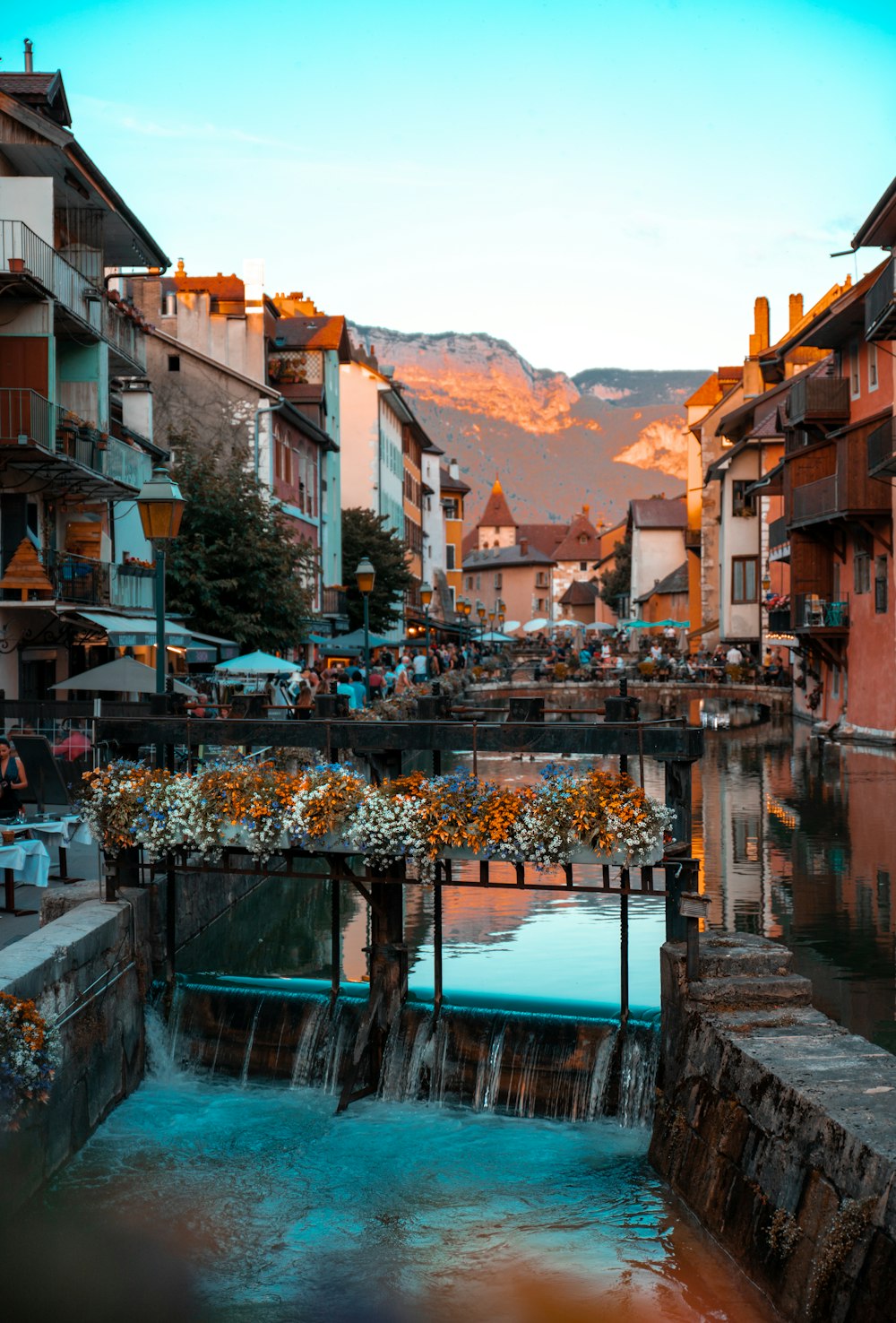 brown and white concrete buildings near body of water during daytime