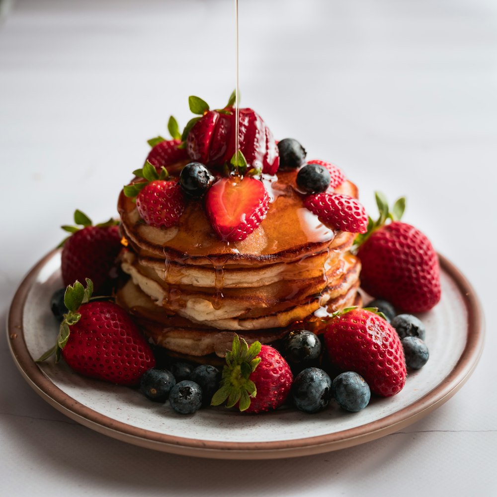 brown and red strawberry cake on white ceramic plate