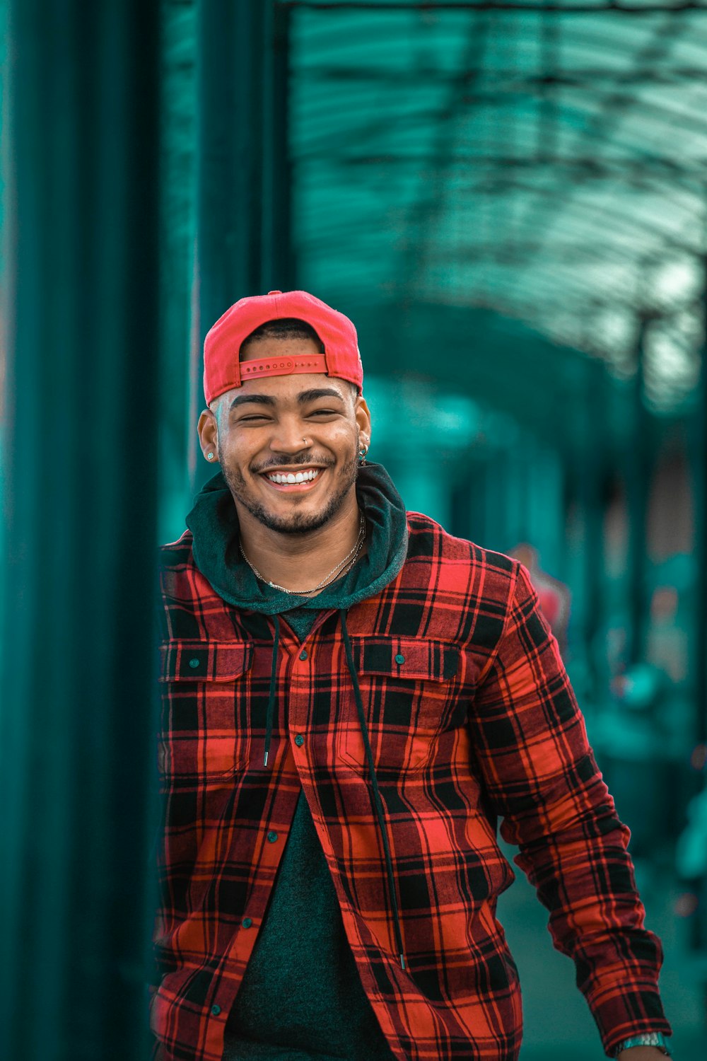 man in red and black plaid dress shirt wearing red knit cap