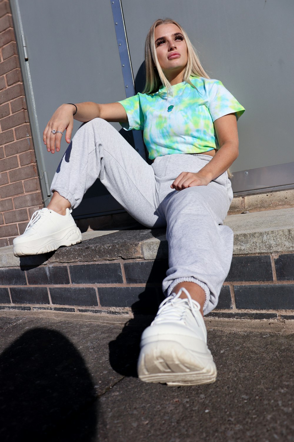 woman in blue denim jeans sitting on stairs