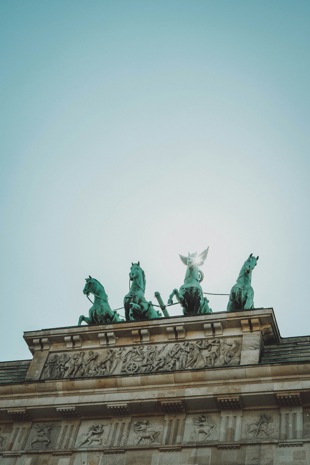 man riding horse statue under white sky