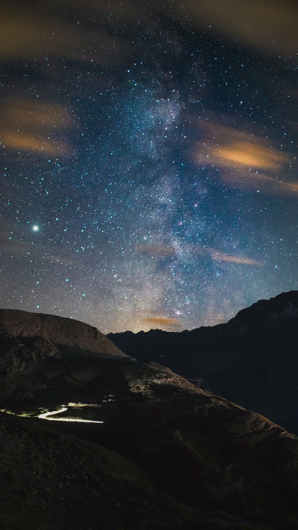 black and white mountain under blue sky with stars during night time