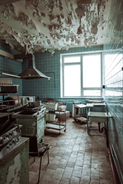 Before and after images of a renovated kitchen with fresh paint and new tiles.
