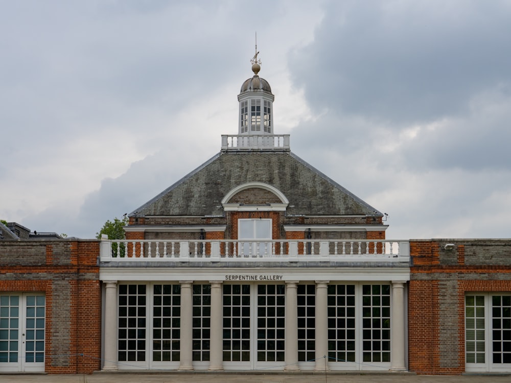 brown and white concrete building under white clouds during daytime