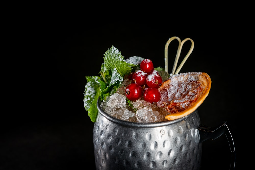 red cherries on stainless steel bowl