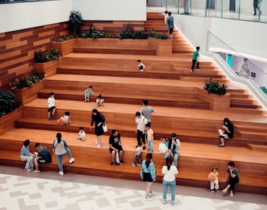people in white shirts walking on brown wooden floor
