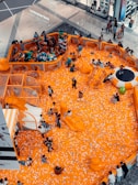 people in white shirt and black pants standing on orange floor