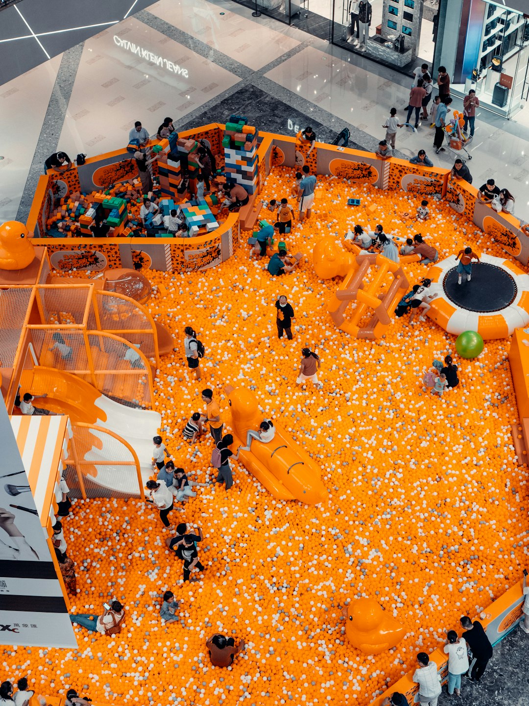 people in white shirt and black pants standing on orange floor