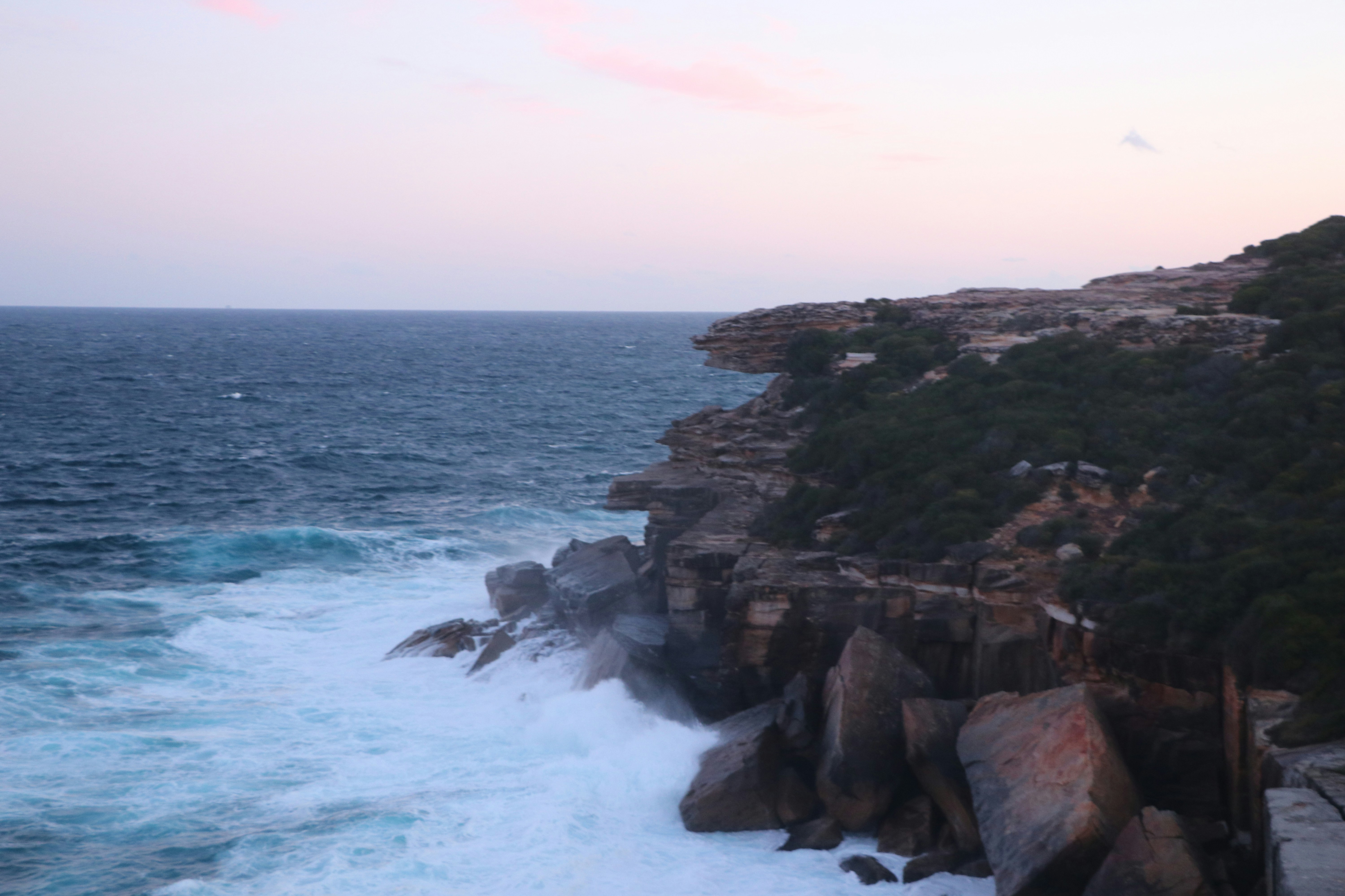 rocky shore with ocean waves during daytime