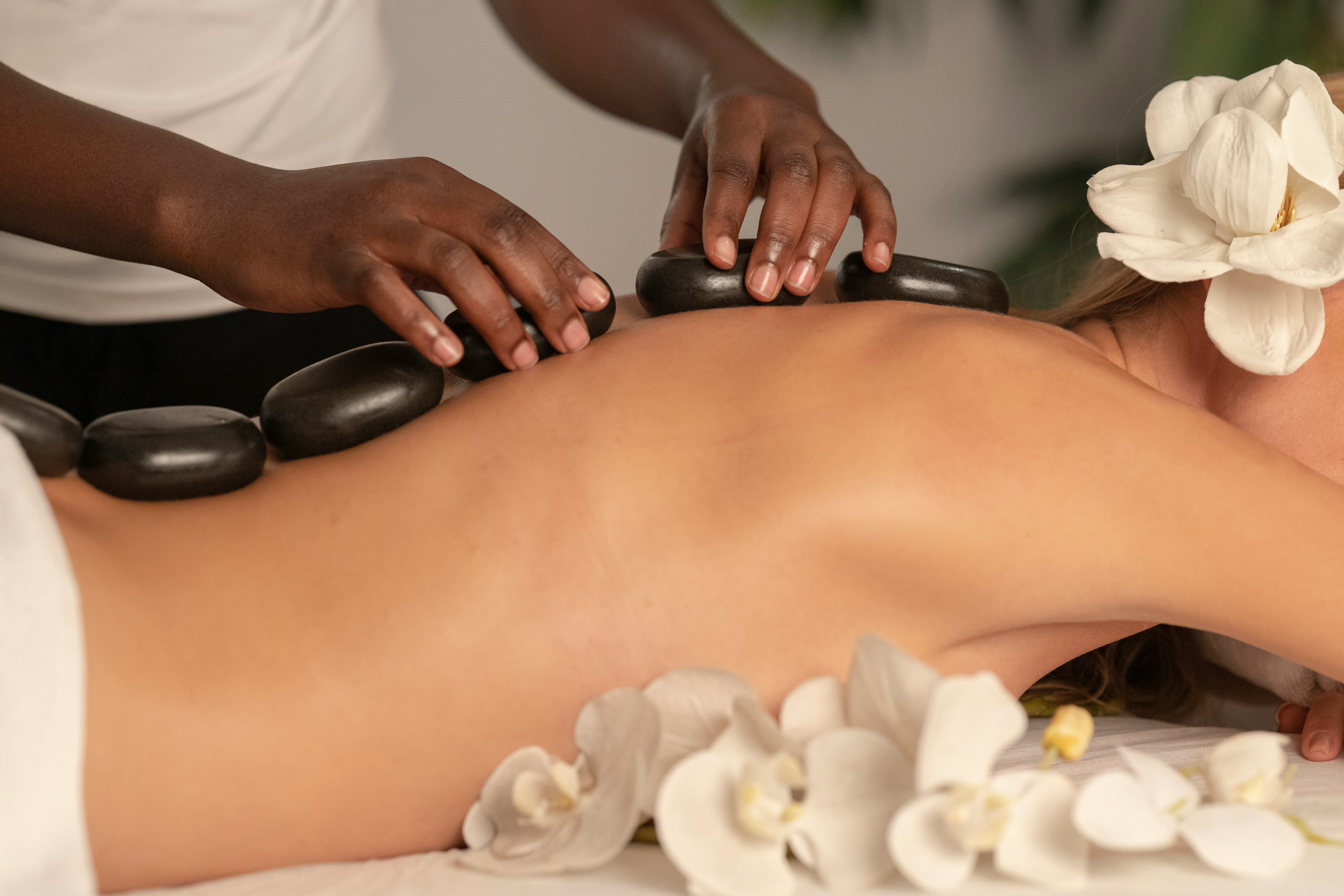 Beautiful Woman Getting Stones Massage in Spa Salon