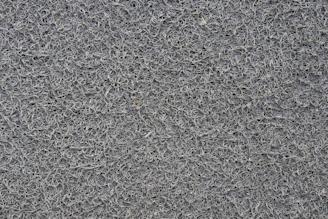 Detailed view of thick net fibers intertwined with metal hooks and fasteners.