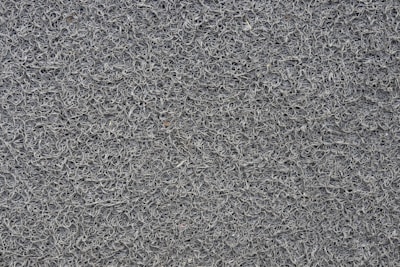 A close-up view of a textured surface composed of numerous intertwined loops or strands, resembling a dense network of fibers.