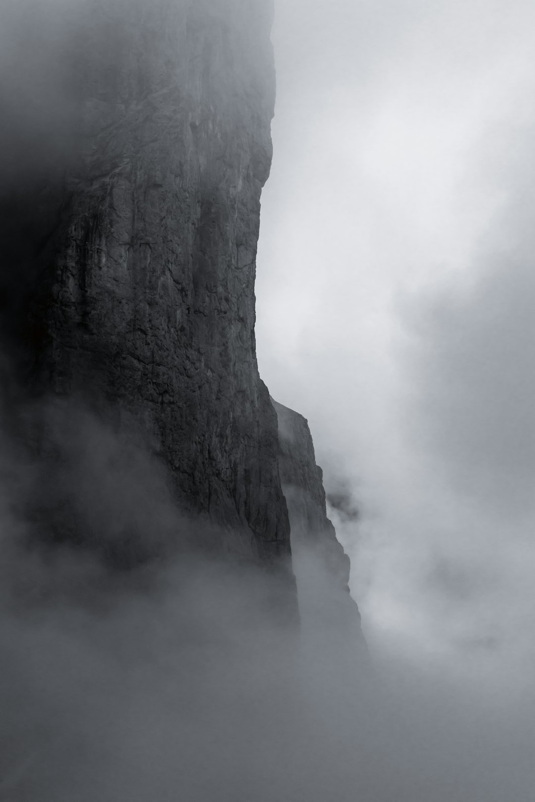 gray rocky mountain under white clouds