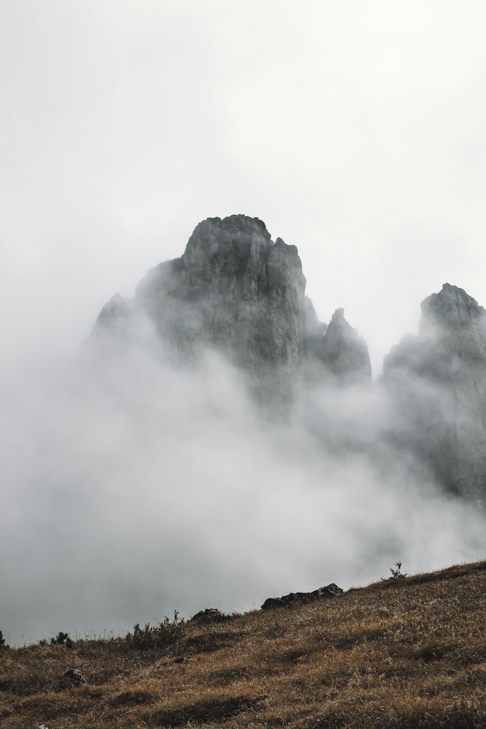 gray and black mountain under white clouds