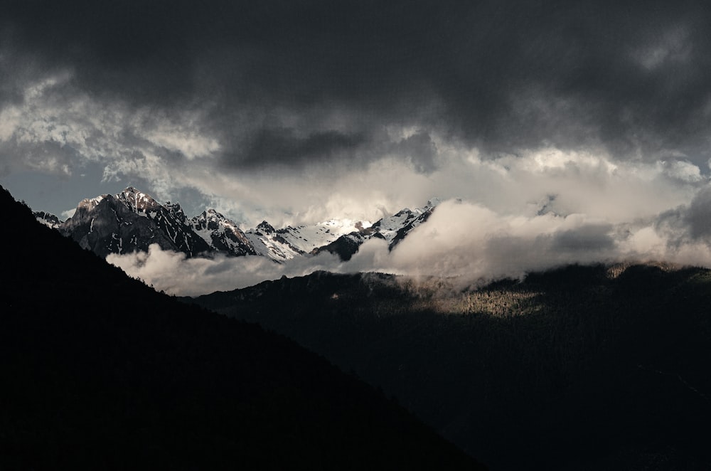 silhouette of mountains under cloudy sky during daytime