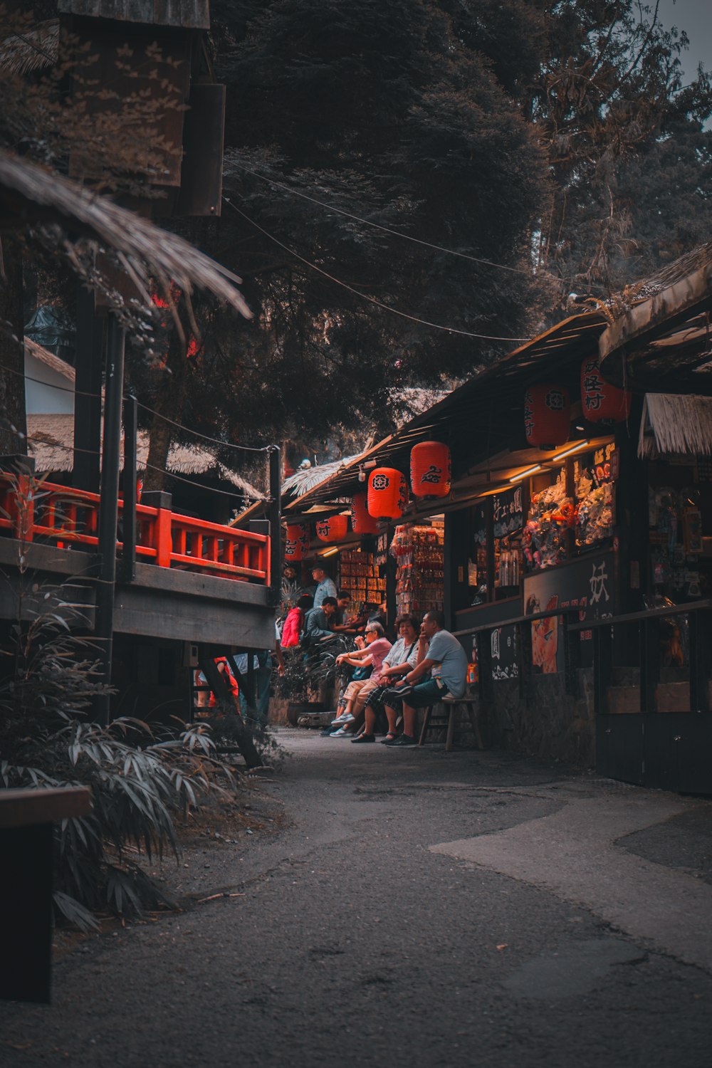 people sitting on bench near store during daytime