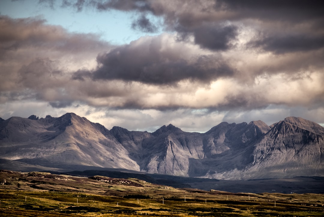 snow covered mountain under cloudy sky during daytime