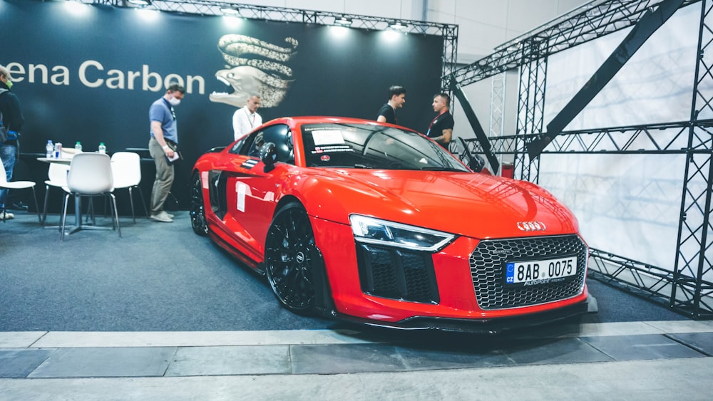 red audi r 8 parked near people