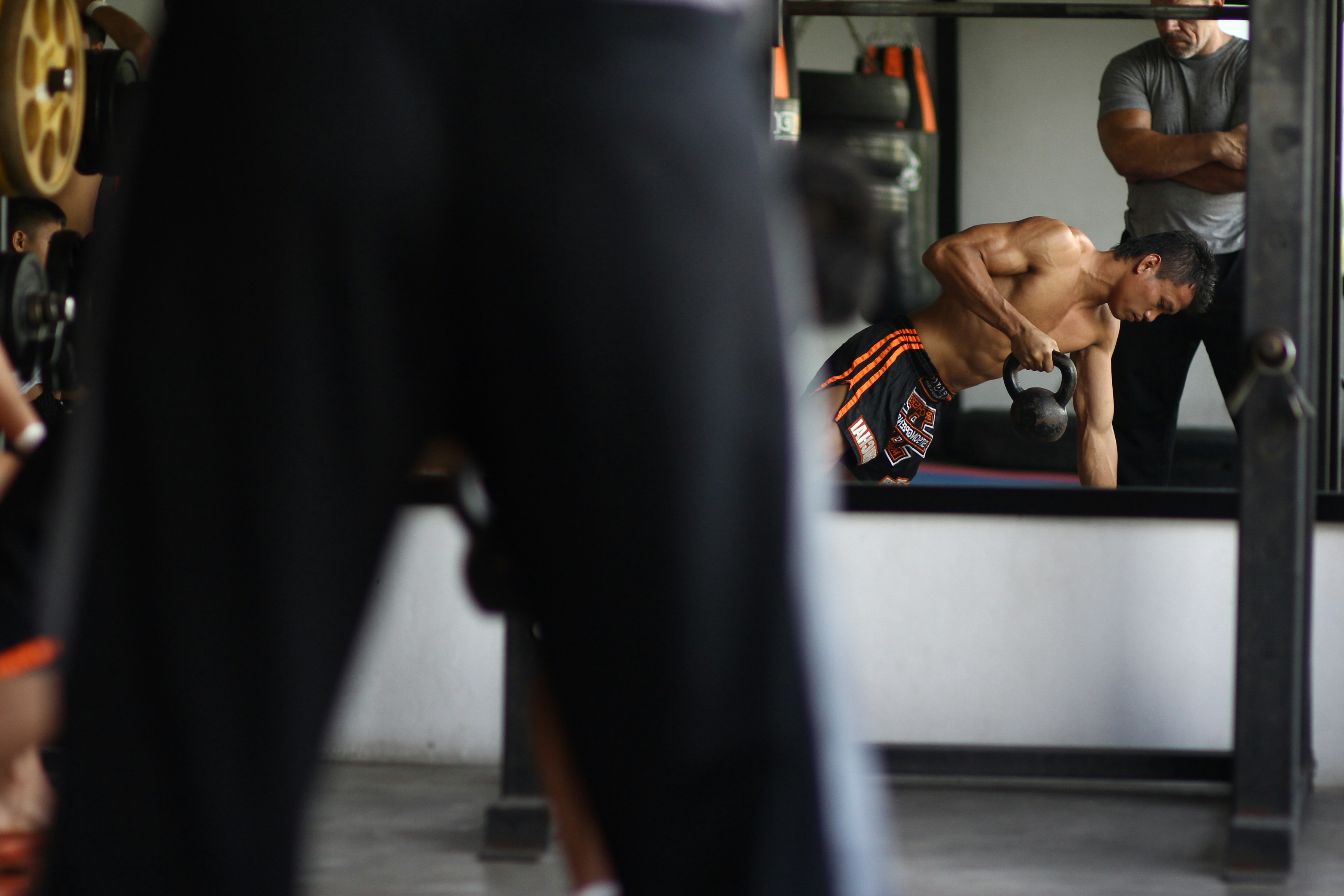 man in black and orange shorts