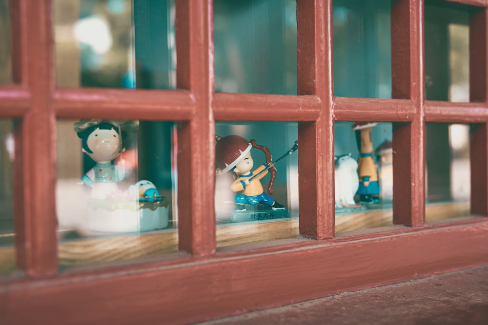 red wooden framed glass window