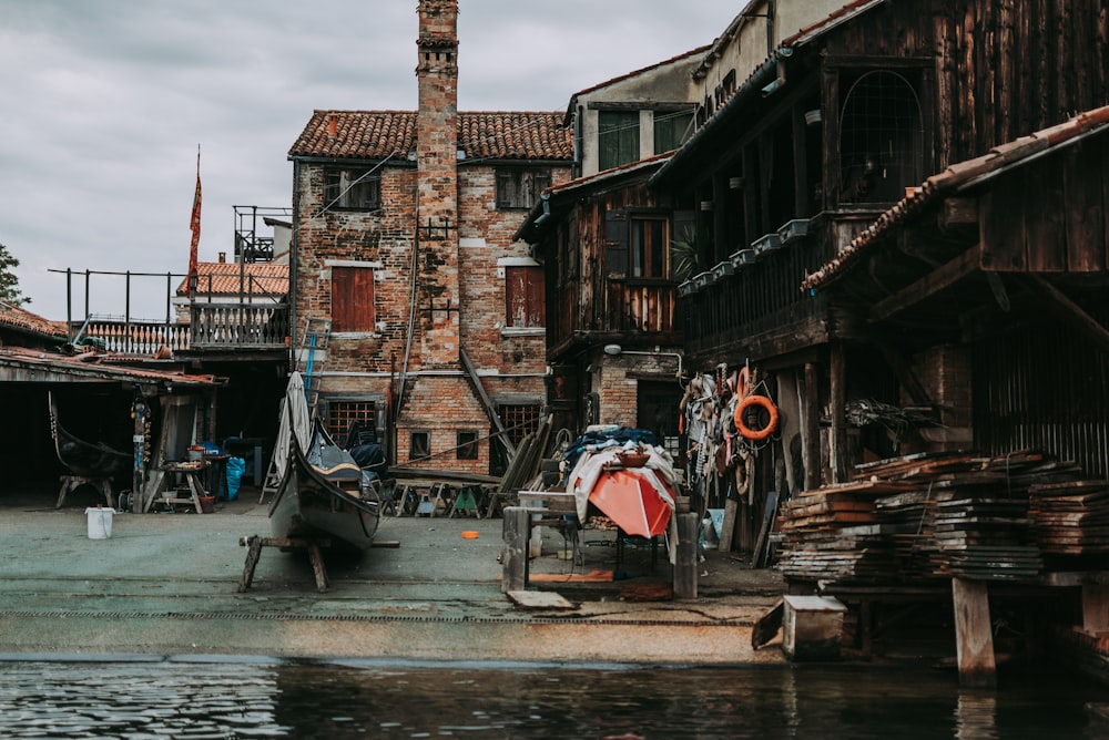 boat on river between buildings during daytime