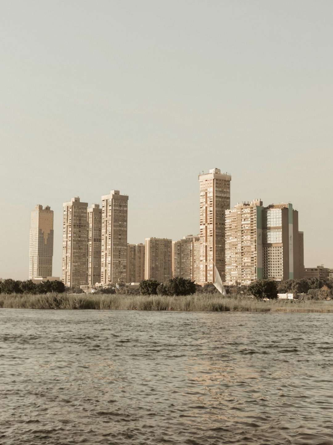 city skyline across body of water during daytime