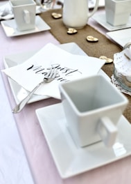 white ceramic mug on white paper