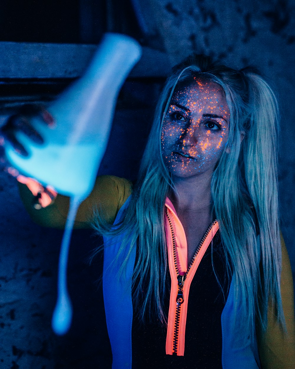 woman in blue and white zip up jacket holding blue plastic cup