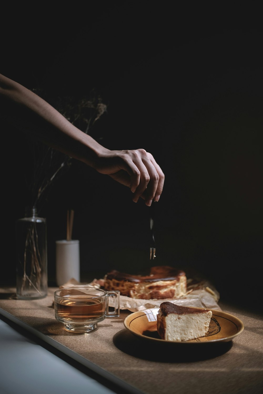 person holding knife slicing bread